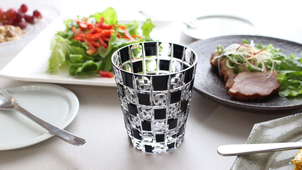 Modern and stylish faceted old glass with black checkerboard pattern ...