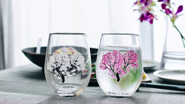 Pair of glasses with cherry blossoms blooming with cold drinks